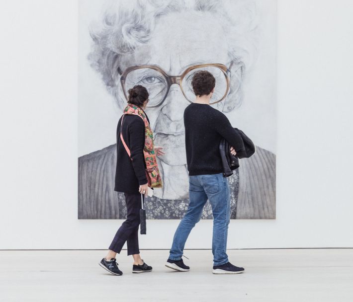 Two people viewing artwork